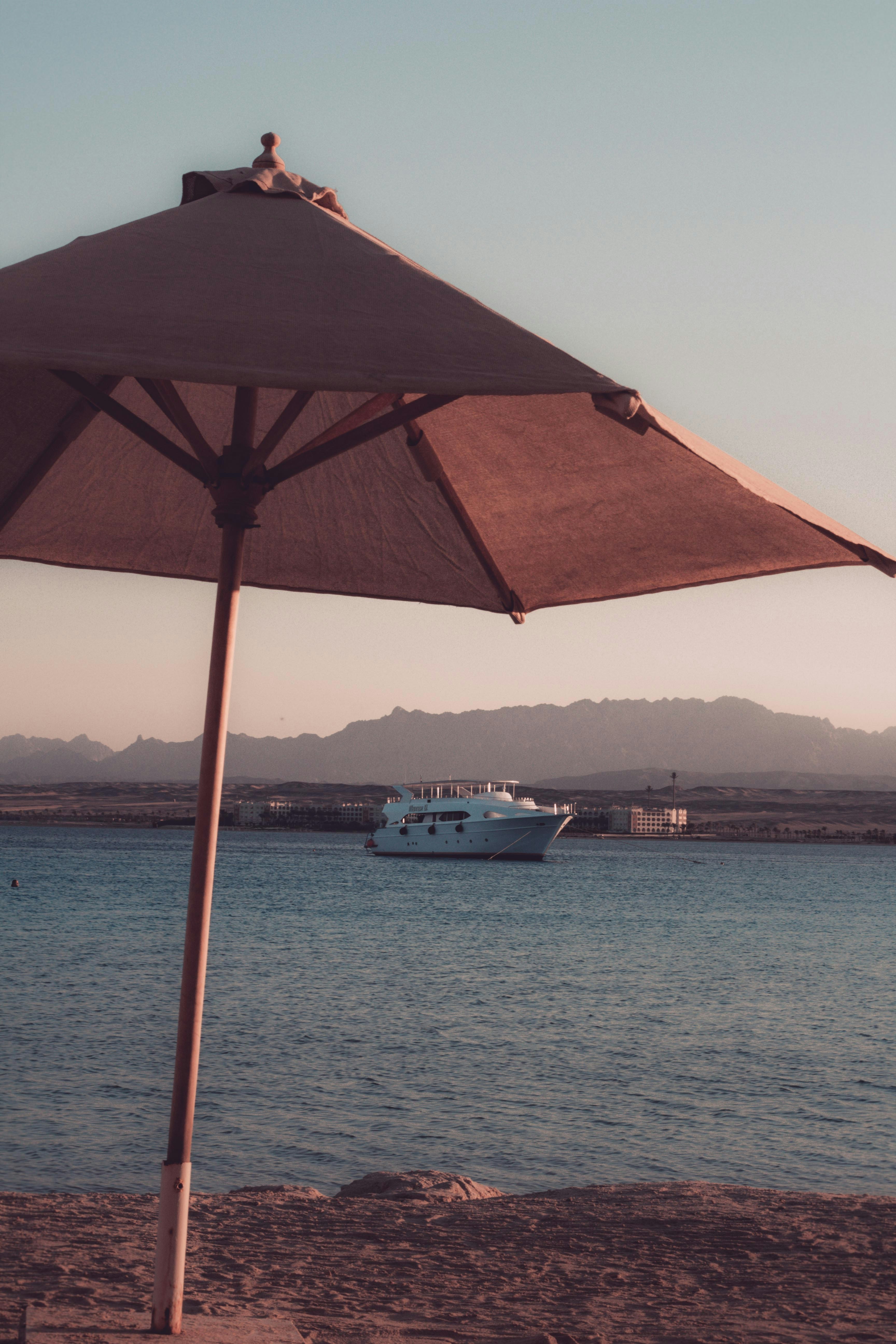 white and blue boat on sea during daytime